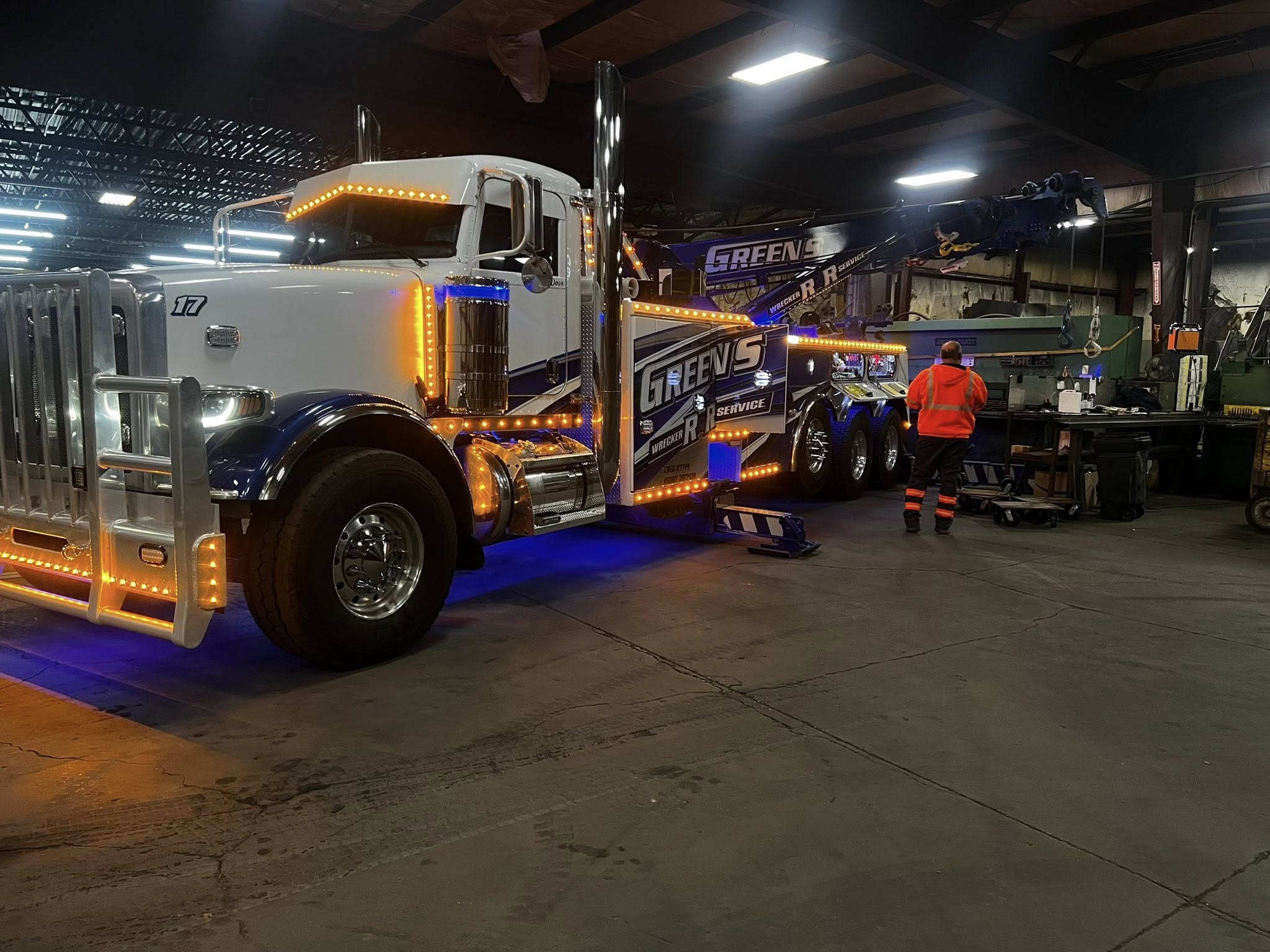 Tracked skid steer with a large winch box attached for towing and recovery.